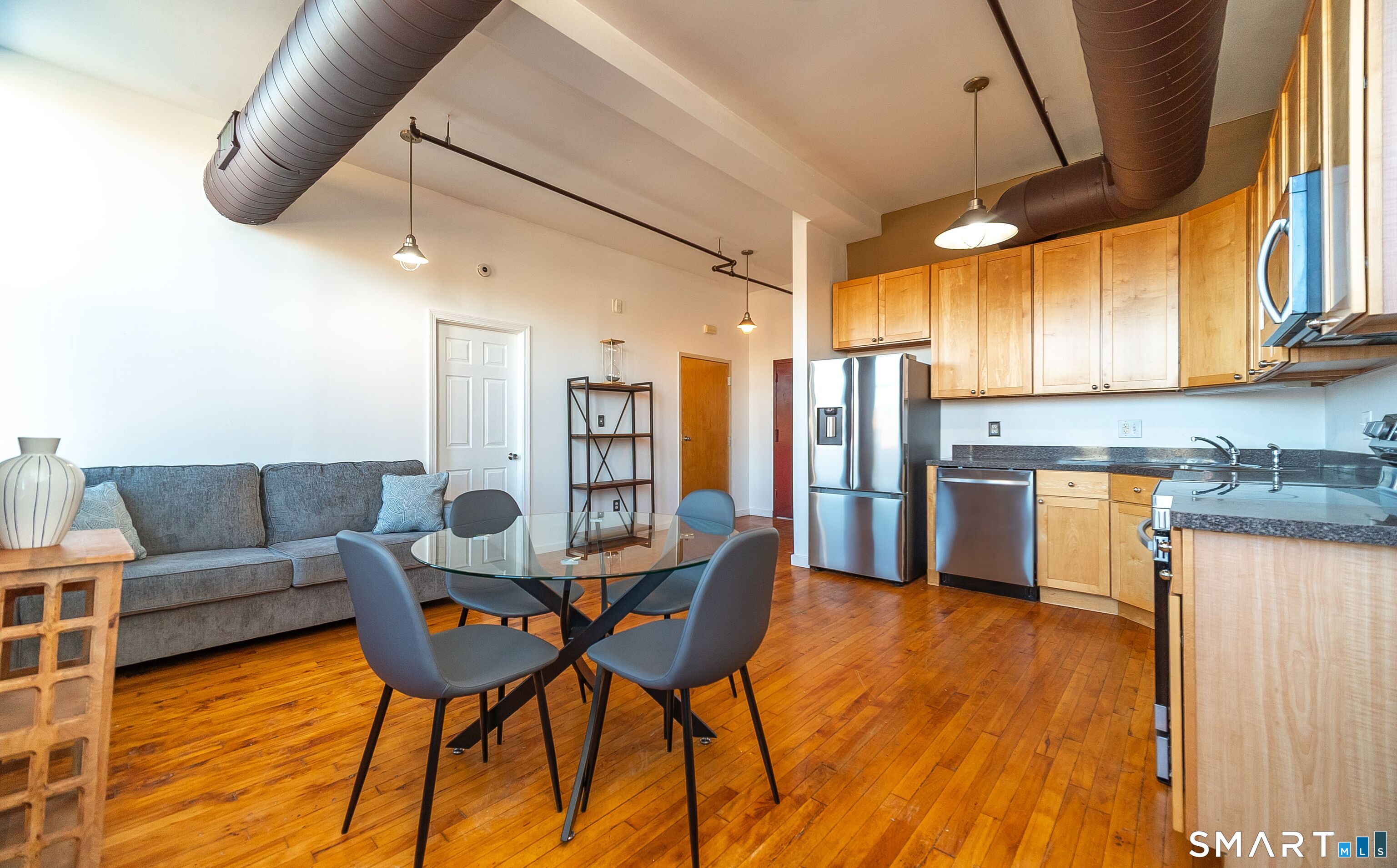 325 Lafayette Street, Unit 8205 Bridgeport, CT 06604 - Photo 3 of 23 a dining room with furniture and wooden floor