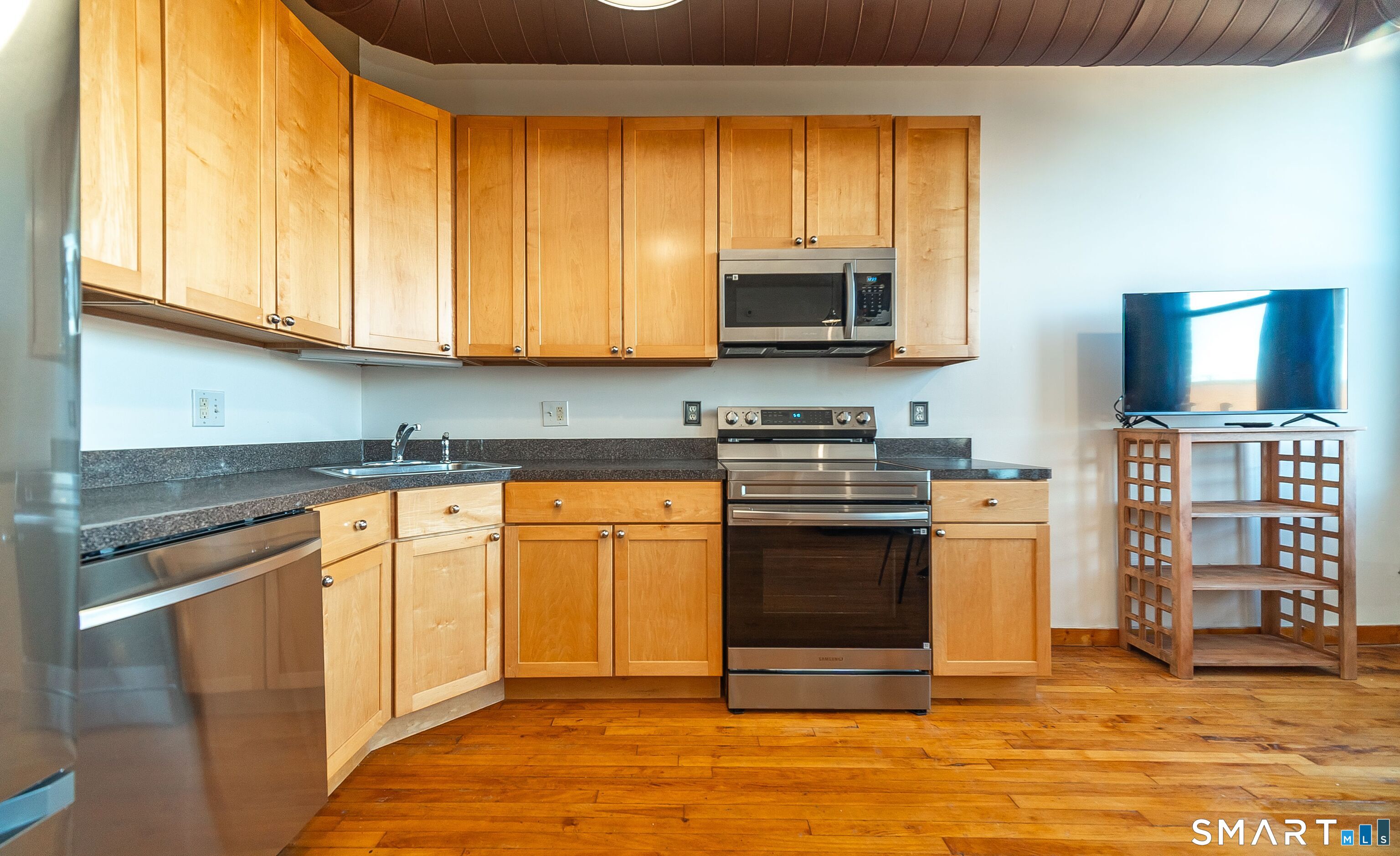 325 Lafayette Street, Unit 8205 Bridgeport, CT 06604 - Photo 5 of 23 a kitchen with stainless steel appliances granite countertop a stove a sink and a microwave