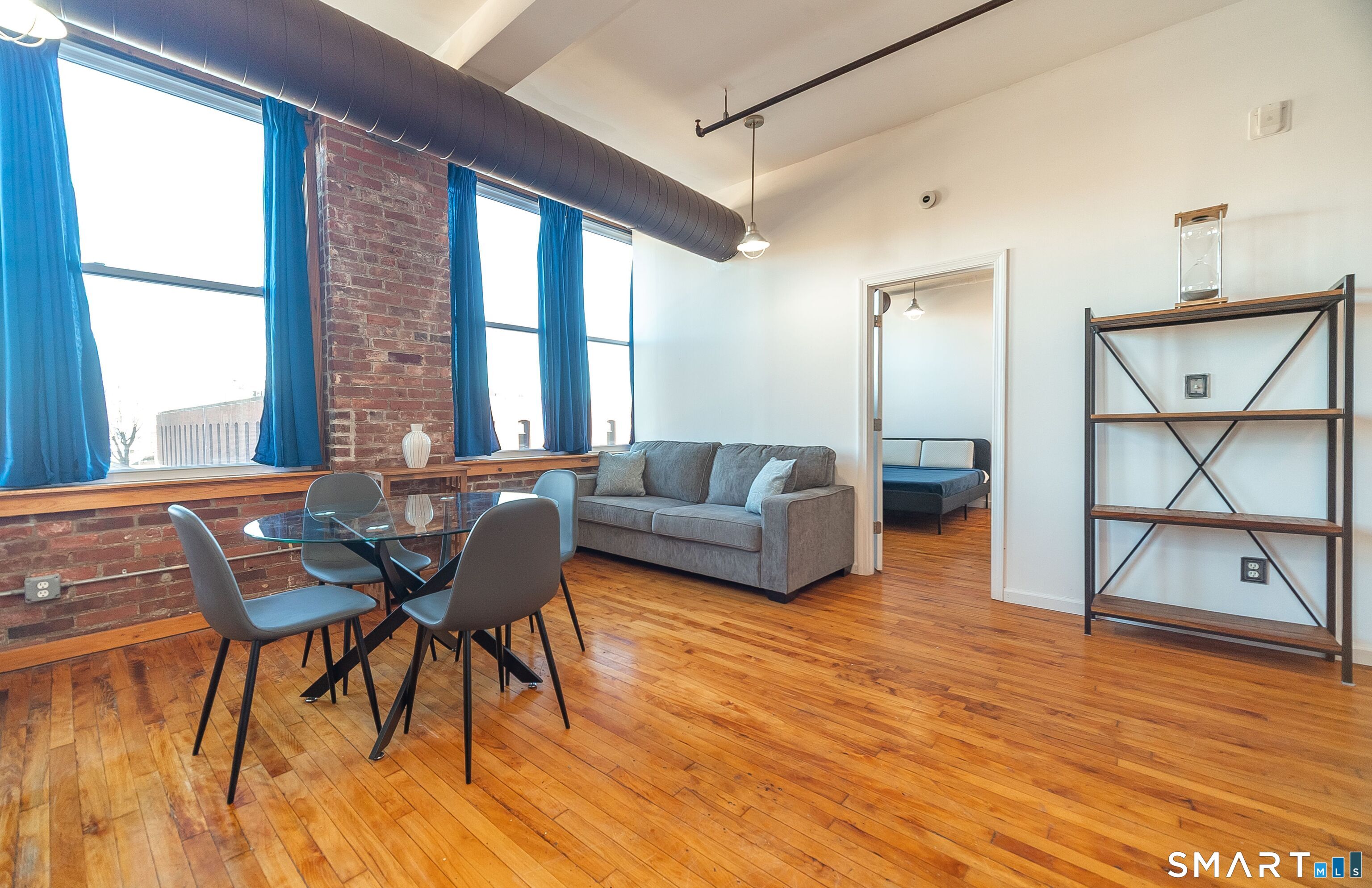 325 Lafayette Street, Unit 8205 Bridgeport, CT 06604 - Photo 7 of 23 a living room with furniture and a wooden floor