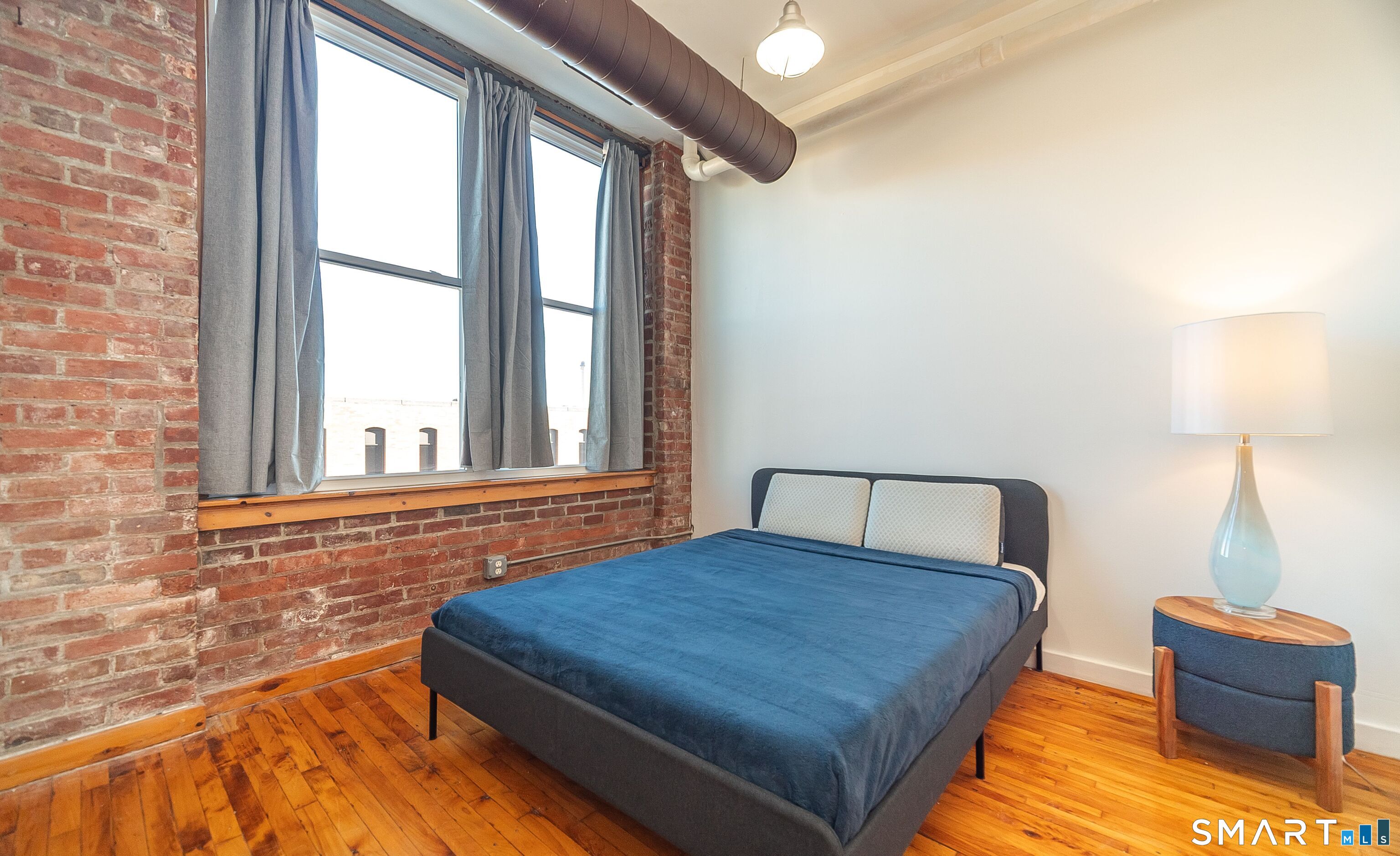 325 Lafayette Street, Unit 8205 Bridgeport, CT 06604 - Photo 9 of 23 a bedroom with a bed and window