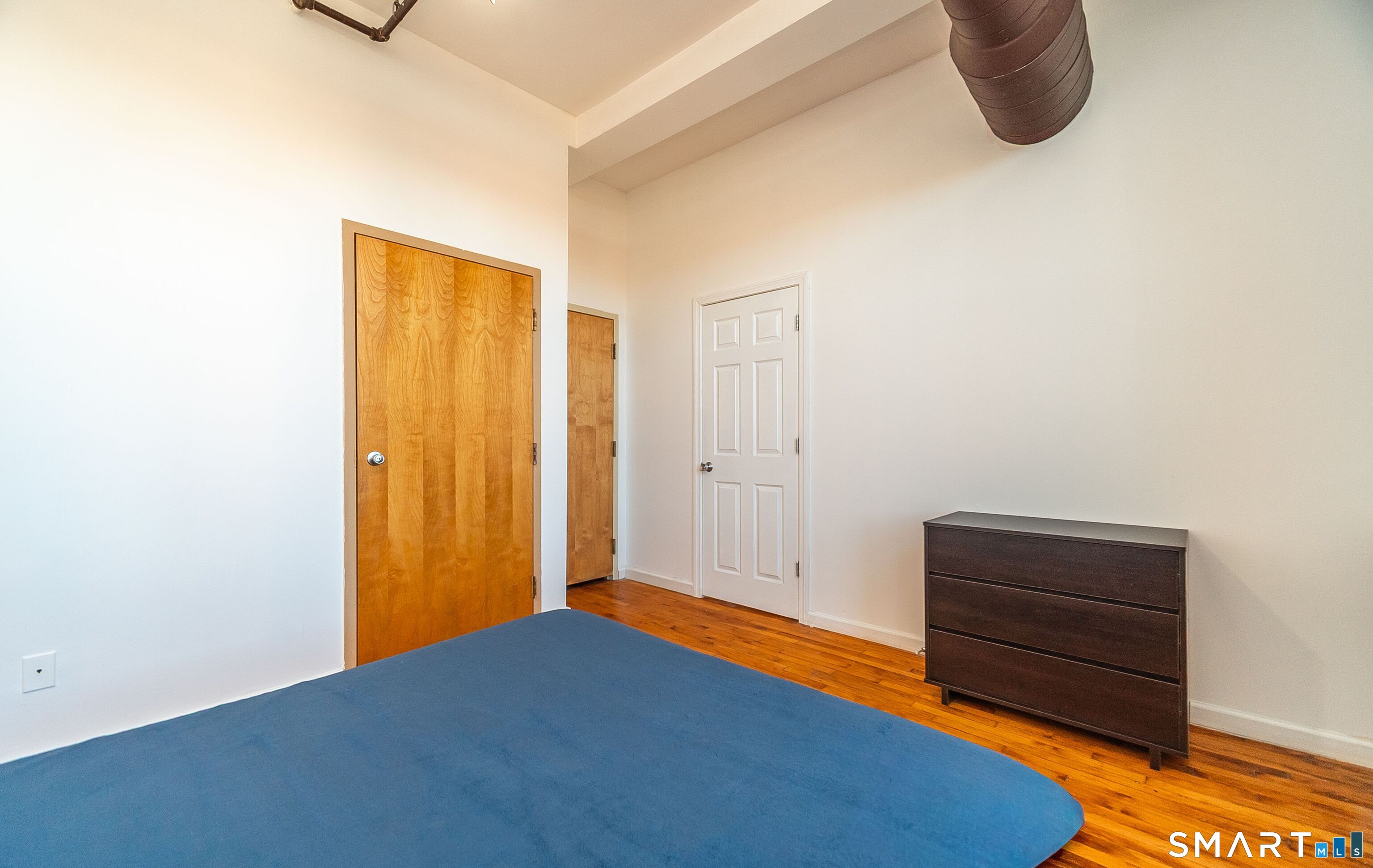 325 Lafayette Street, Unit 8205 Bridgeport, CT 06604 - Photo 10 of 23 a bedroom with a bed and cabinets