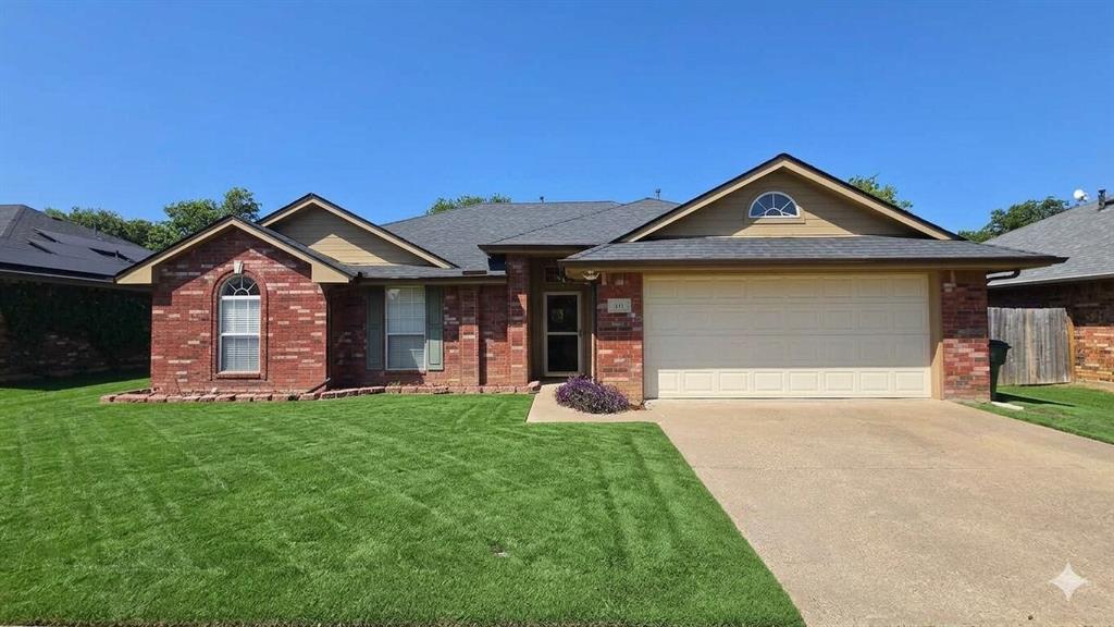 211 Vista Ridge Drive Venus, TX 76084 - Photo 1 of 24 Brick exterior featuring a two-car garage, arched window, and landscaped front yard