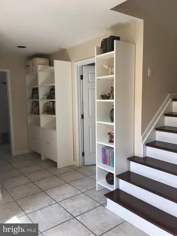 a view of a livingroom with furniture and staircase