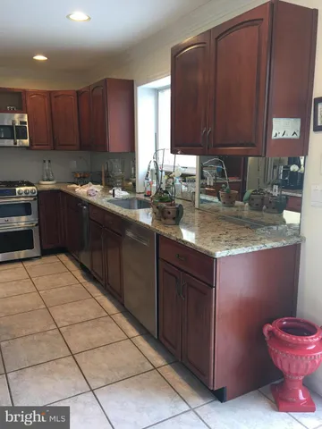 a kitchen with a sink a stove and cabinets