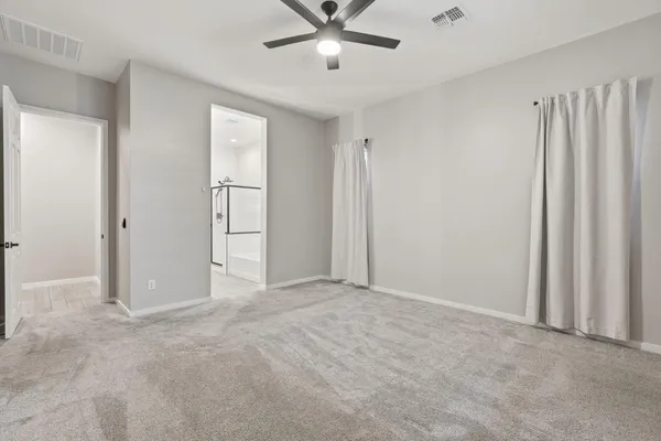 an empty room with closet and windows