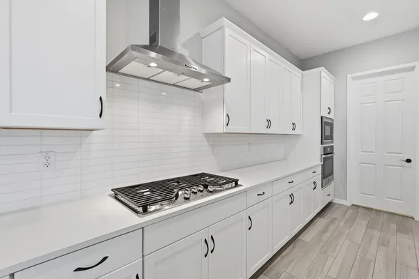 a stove top oven sitting inside of a kitchen