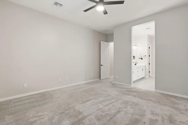 an empty room with chandelier fan
