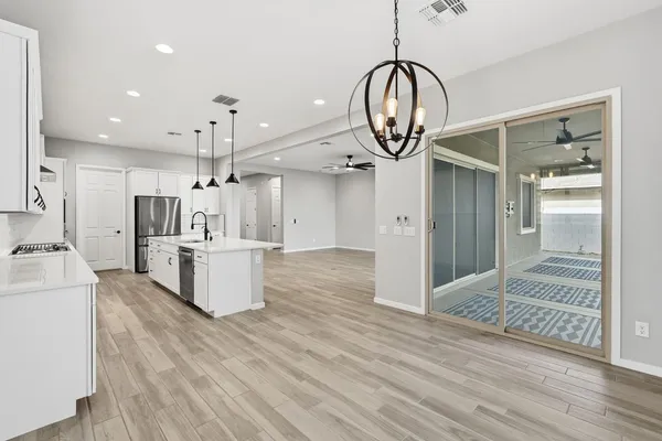 a view of kitchen with cabinets and wooden floor