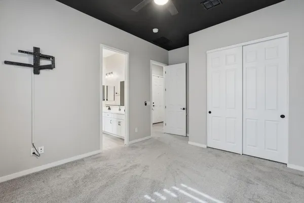 a view of a hallway with closet and mirror