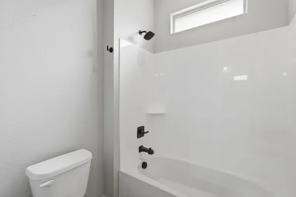 a bathroom with a toilet and bathtub