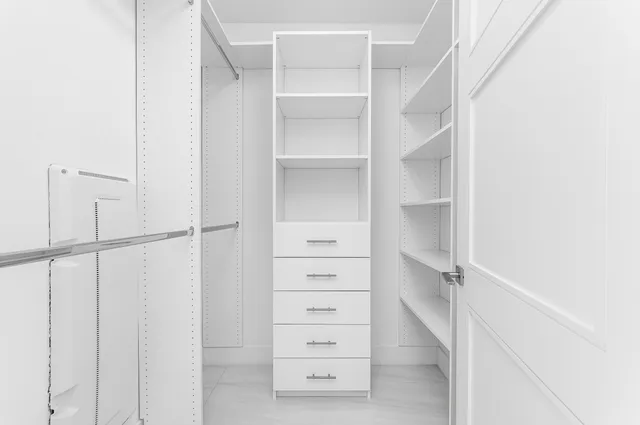 a view of walk in closet with empty racks