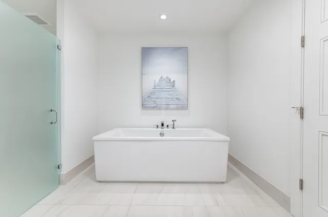 a large white bed in a white room