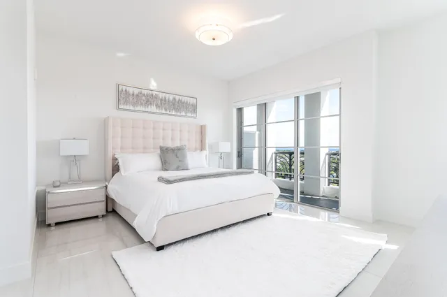 a bedroom with a bed and glass walk in closet