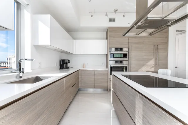 a large kitchen with a sink and cabinets