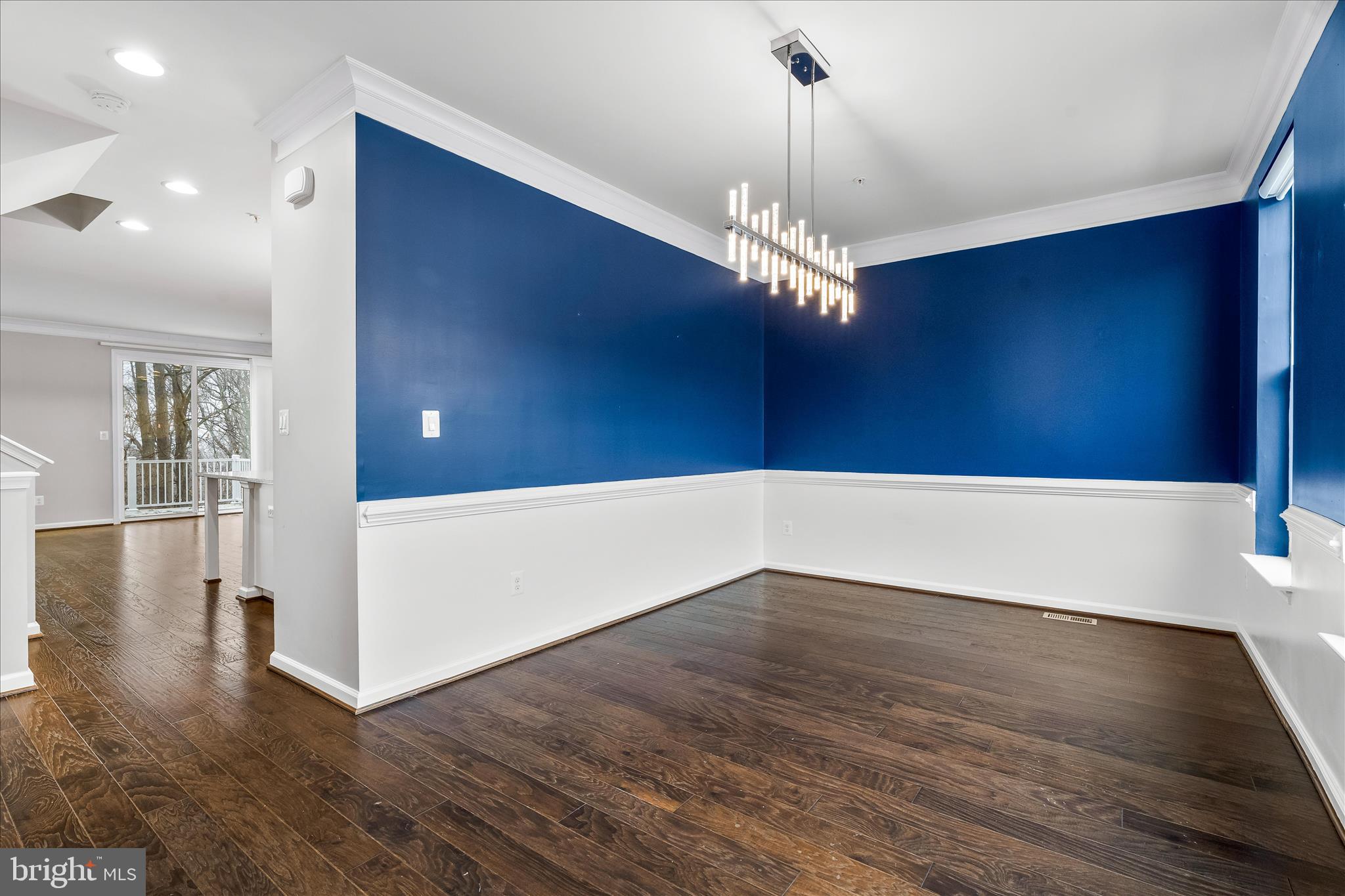 5642 Scott Ridge Place Frederick, MD 21704 - Photo 5 of 7 a view of a hallway with wooden floor and chandelier