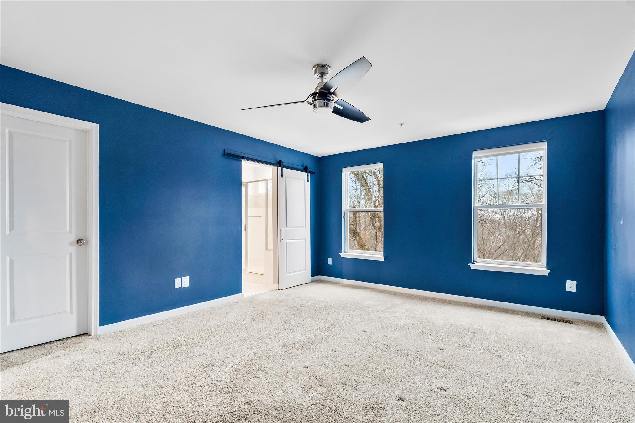 5642 Scott Ridge Place Frederick, MD 21704 - Photo 6 of 7 a view of a livingroom with a ceiling fan and windows