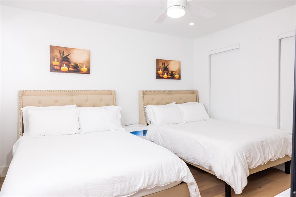 1402 Braes Ridge Drive, Unit B Austin, TX 78723 - Photo 7 of 13 a bedroom with two beds and a painting on the wall