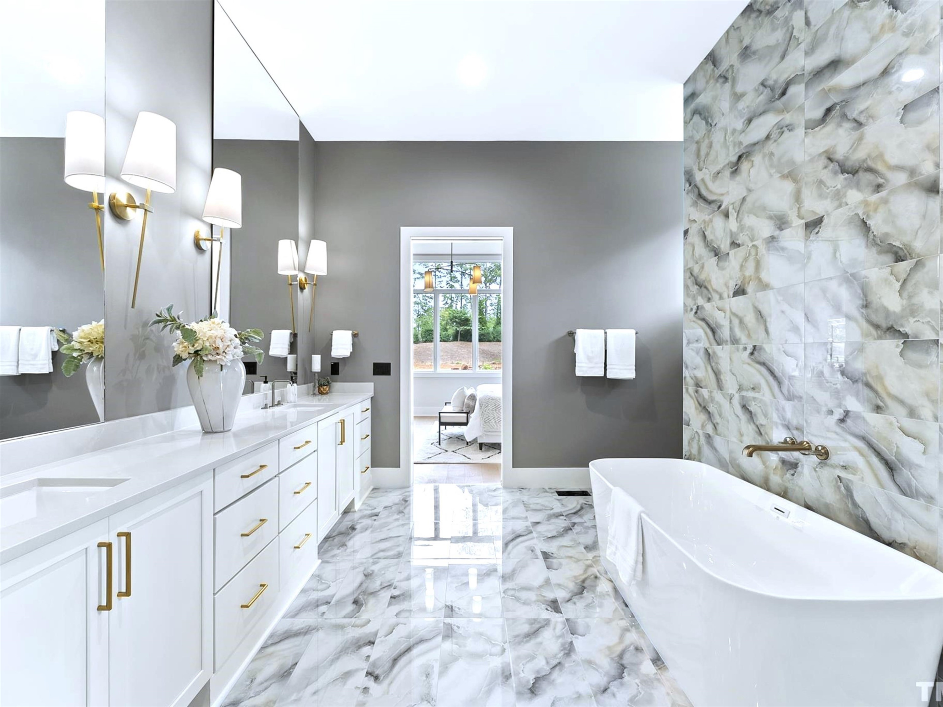 1001 Enchanted Pine Lane Raleigh, NC 27614 - Photo 29 of 52 a spacious bathroom with a double vanity sink a mirror a bathtub and a toilet
