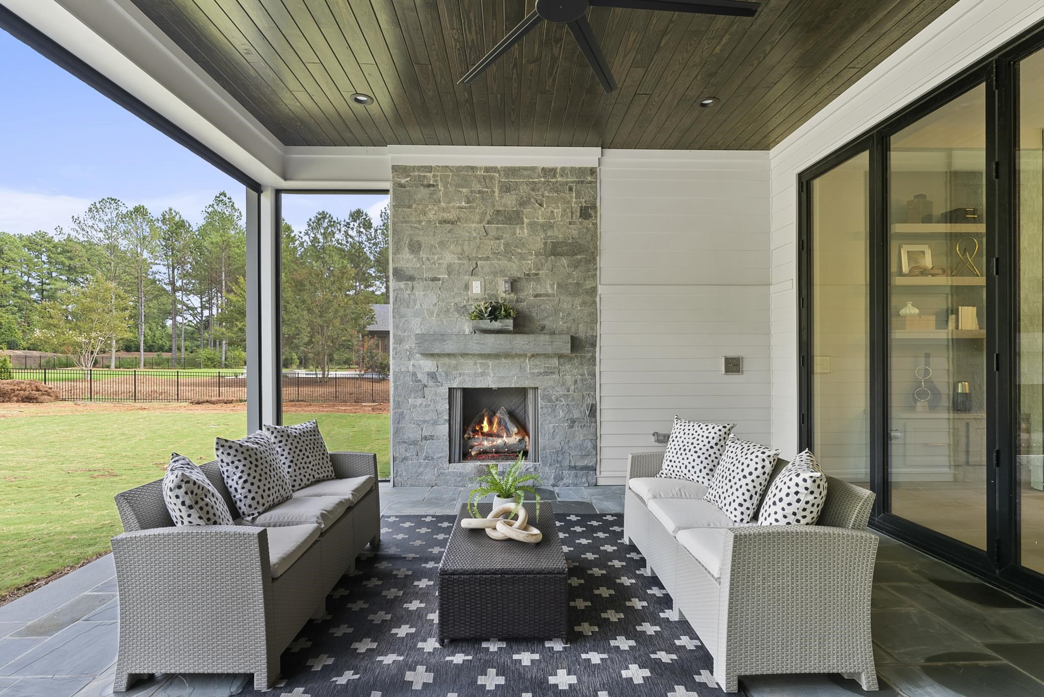 1001 Enchanted Pine Lane Raleigh, NC 27614 - Photo 51 of 52 a living room with furniture a fireplace and a floor to ceiling window