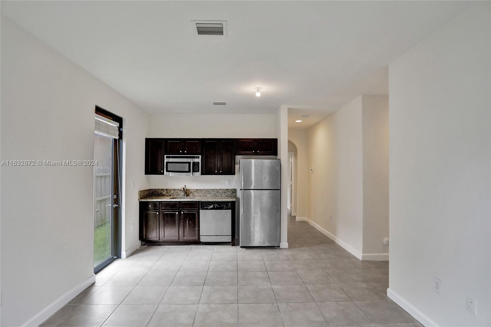 588 Southeast 35th Terrace Homestead, FL 33033 - Photo 12 of 37 a view of a kitchen with a sink and a refrigerator