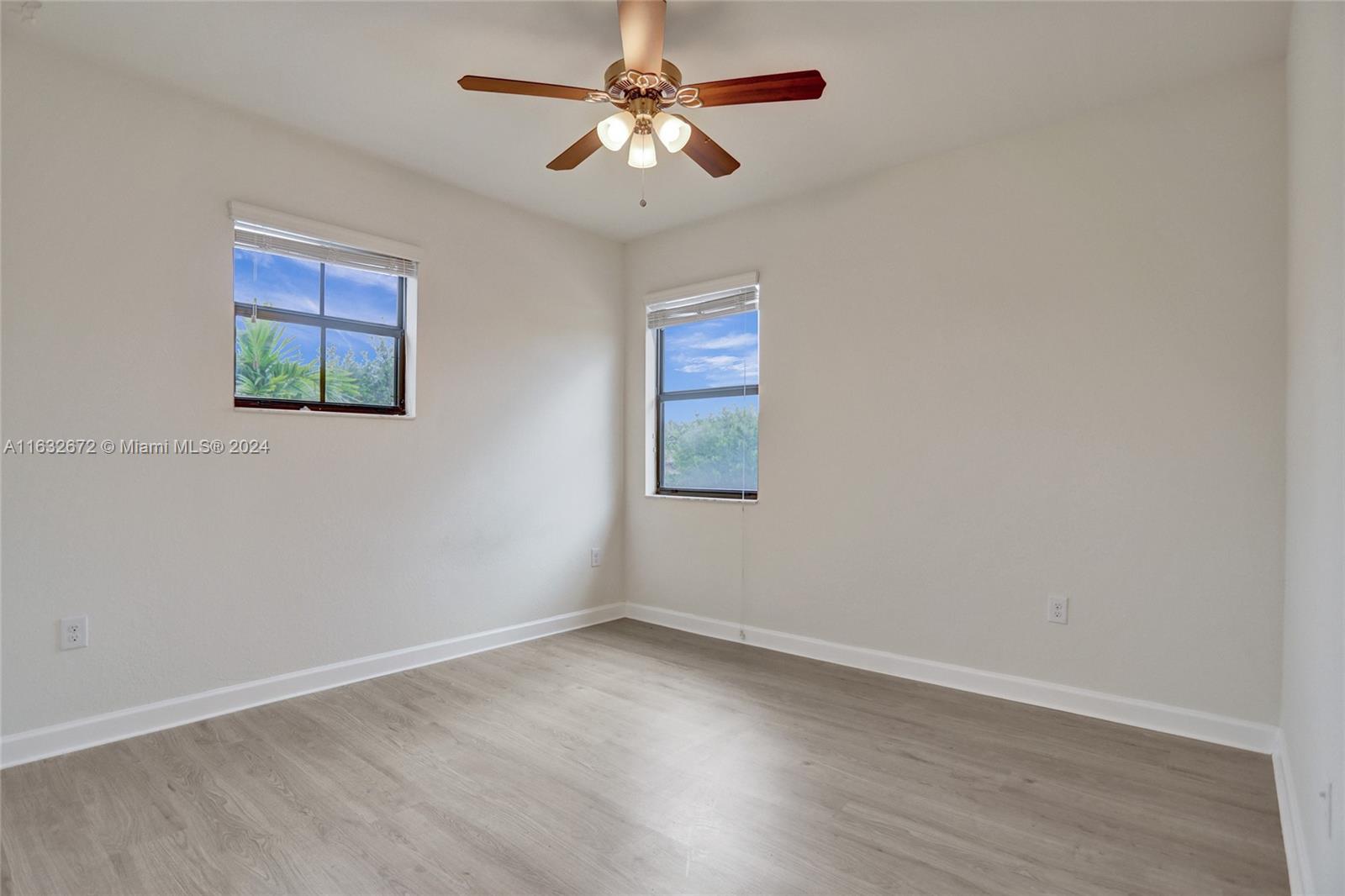 588 Southeast 35th Terrace Homestead, FL 33033 - Photo 16 of 37 an empty room with a window and a fan