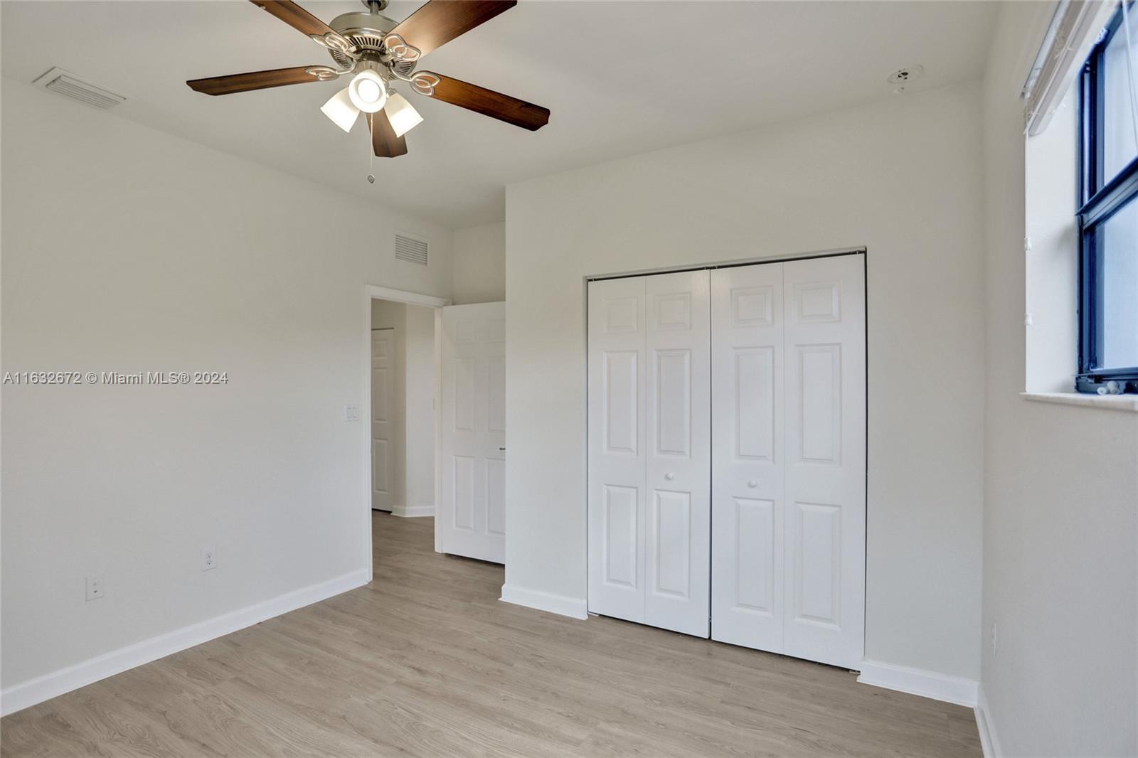 588 Southeast 35th Terrace Homestead, FL 33033 - Photo 17 of 37 a view of an empty room with a fan
