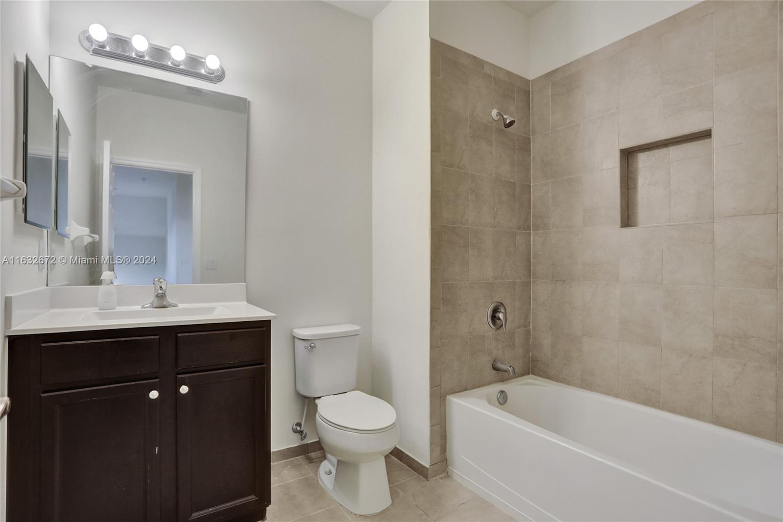 588 Southeast 35th Terrace Homestead, FL 33033 - Photo 18 of 37 a bathroom with a bathtub shower sink mirror and toilet