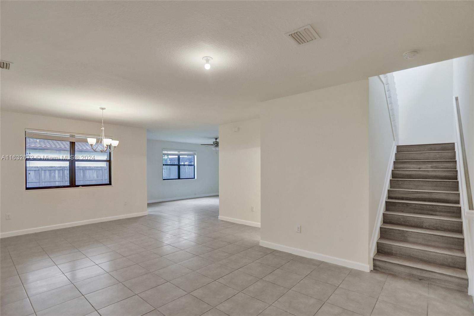 588 Southeast 35th Terrace Homestead, FL 33033 - Photo 5 of 37 an empty room with windows and stairs