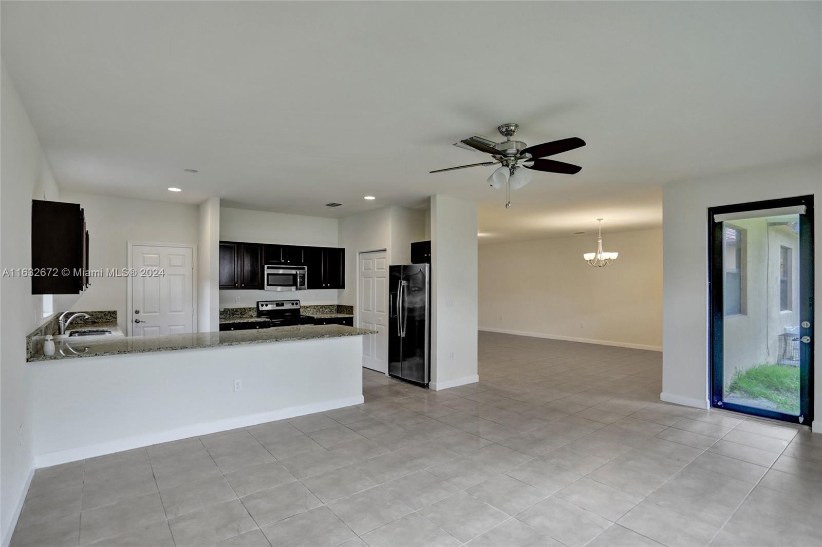 588 Southeast 35th Terrace Homestead, FL 33033 - Photo 7 of 37 a view of a kitchen with a sink and a ceiling fan