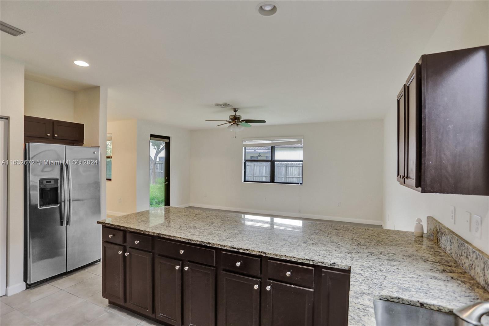 588 Southeast 35th Terrace Homestead, FL 33033 - Photo 9 of 37 a kitchen with stainless steel appliances granite countertop a refrigerator and a sink