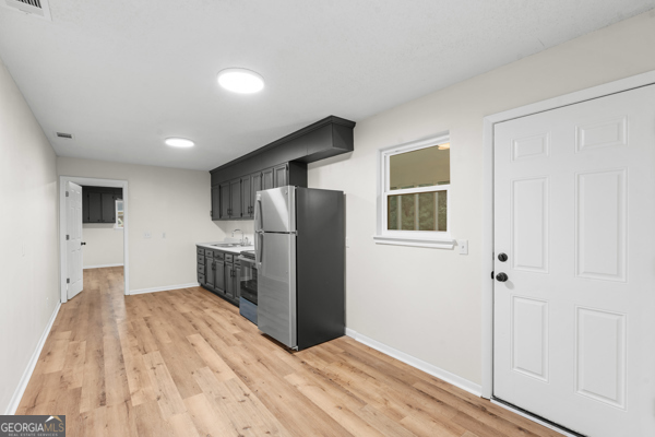 529 College Heights Road Portal, GA 30450 - Photo 11 of 23 a bedroom with a bed and a refrigerator