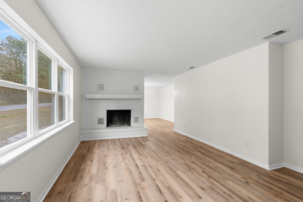 529 College Heights Road Portal, GA 30450 - Photo 8 of 23 wooden floor fireplace and windows in an empty room