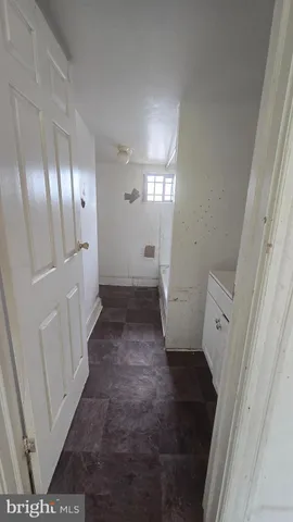 a view of a hallway with a washer and dryer
