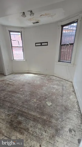 a view of an empty room with windows