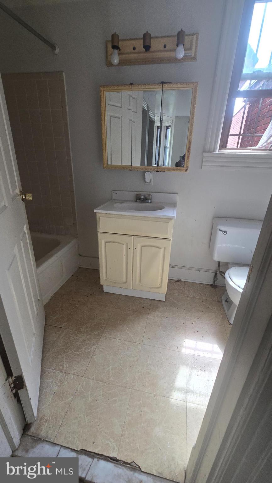 1126 Park Road Northwest Washington, DC 20010 - Photo 6 of 8 a bathroom with a sink a mirror and a bathtub