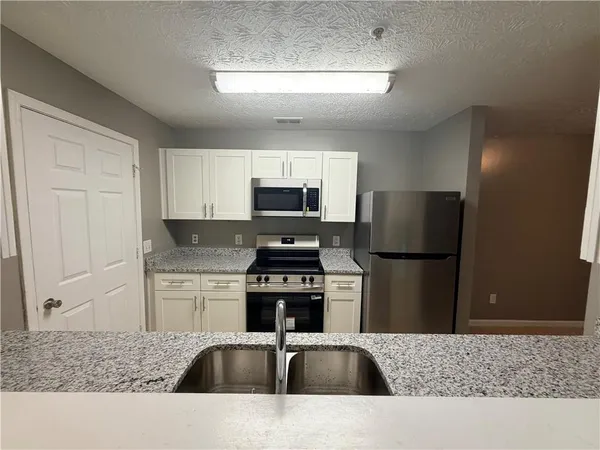 a kitchen with a refrigerator and a sink