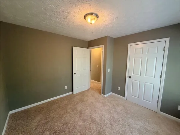 an empty room with windows and closet