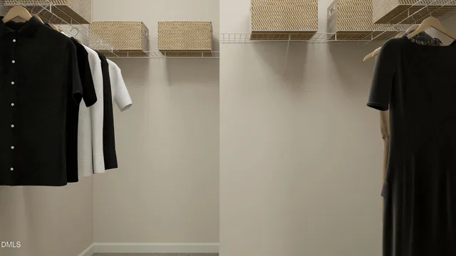a view of walk in closet with clothes and shoes