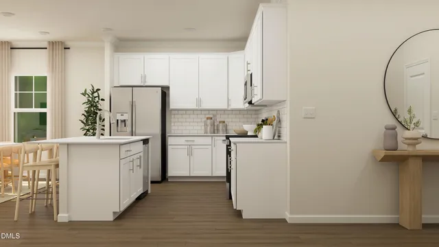 a kitchen with stainless steel appliances a refrigerator sink and cabinets