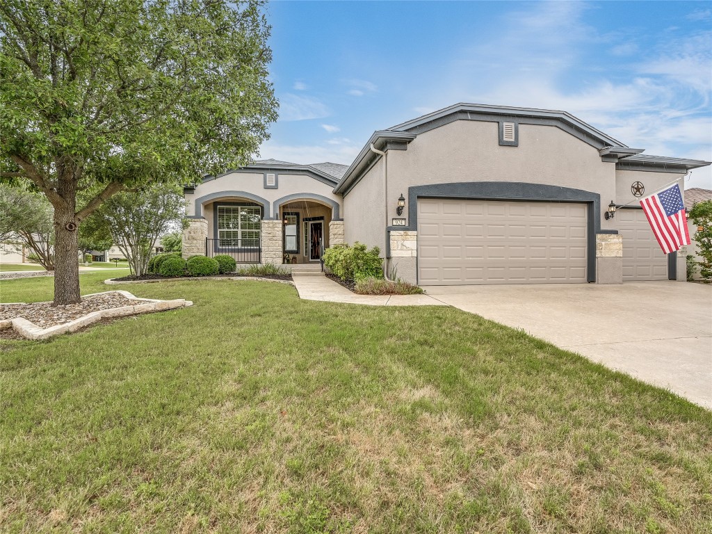 a front view of a house with a yard and garage