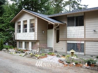 21104 Shell Valley Road Edmonds, WA 98026 - Photo 1 of 1 a front view of a house with yard and trees
