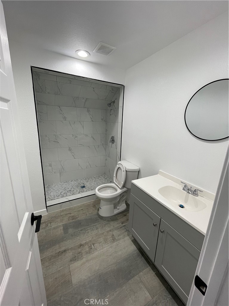 2588 Secret Drive Running Springs, CA 92382 - Photo 11 of 24 a bathroom with a granite countertop sink toilet and a mirror