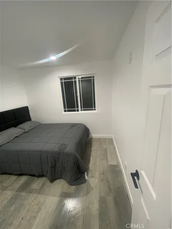 a bedroom with a bed and painting on the wall