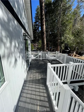 a view of balcony with wooden floor and fence