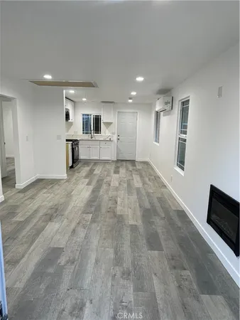 a view of a livingroom with an empty space and a window