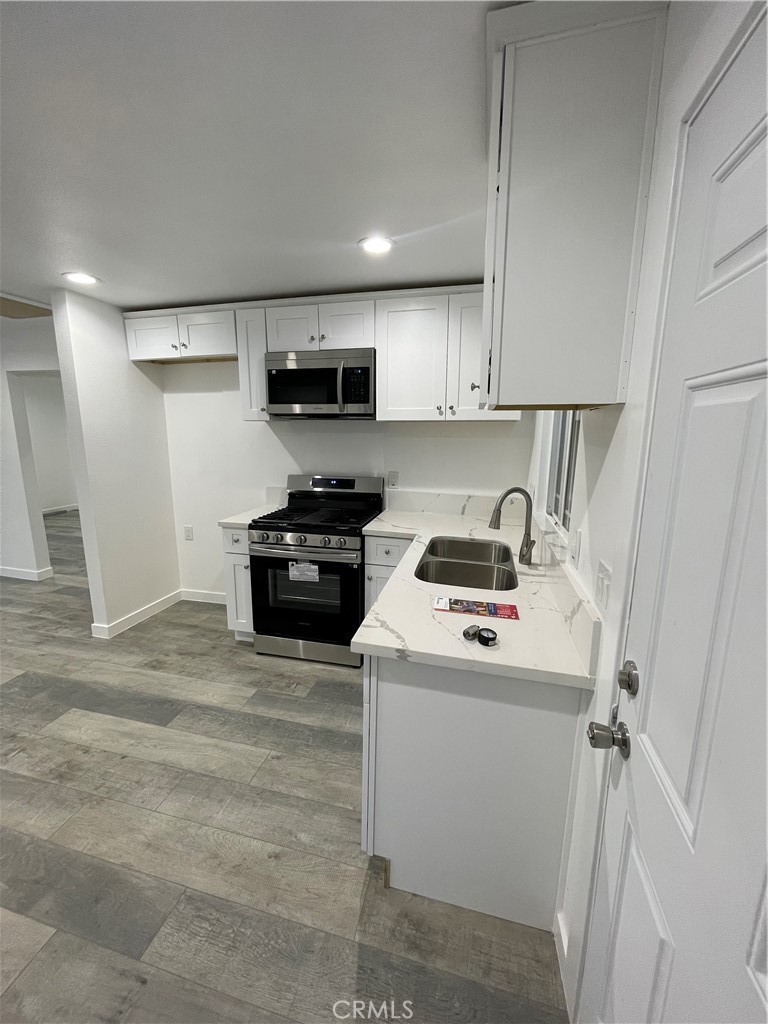 2588 Secret Drive Running Springs, CA 92382 - Photo 10 of 24 a kitchen with a sink a stove a refrigerator and cabinets