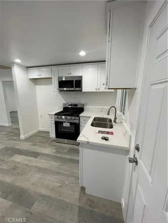 a kitchen with a sink a stove and refrigerator