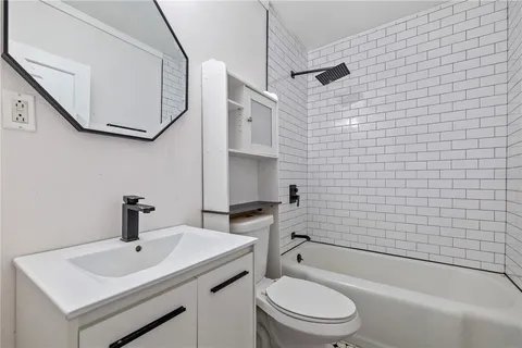 a bathroom with a sink a toilet and bathtub