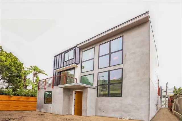 a front view of a residential apartment building with a yard