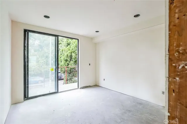 a view of an empty room with glass door